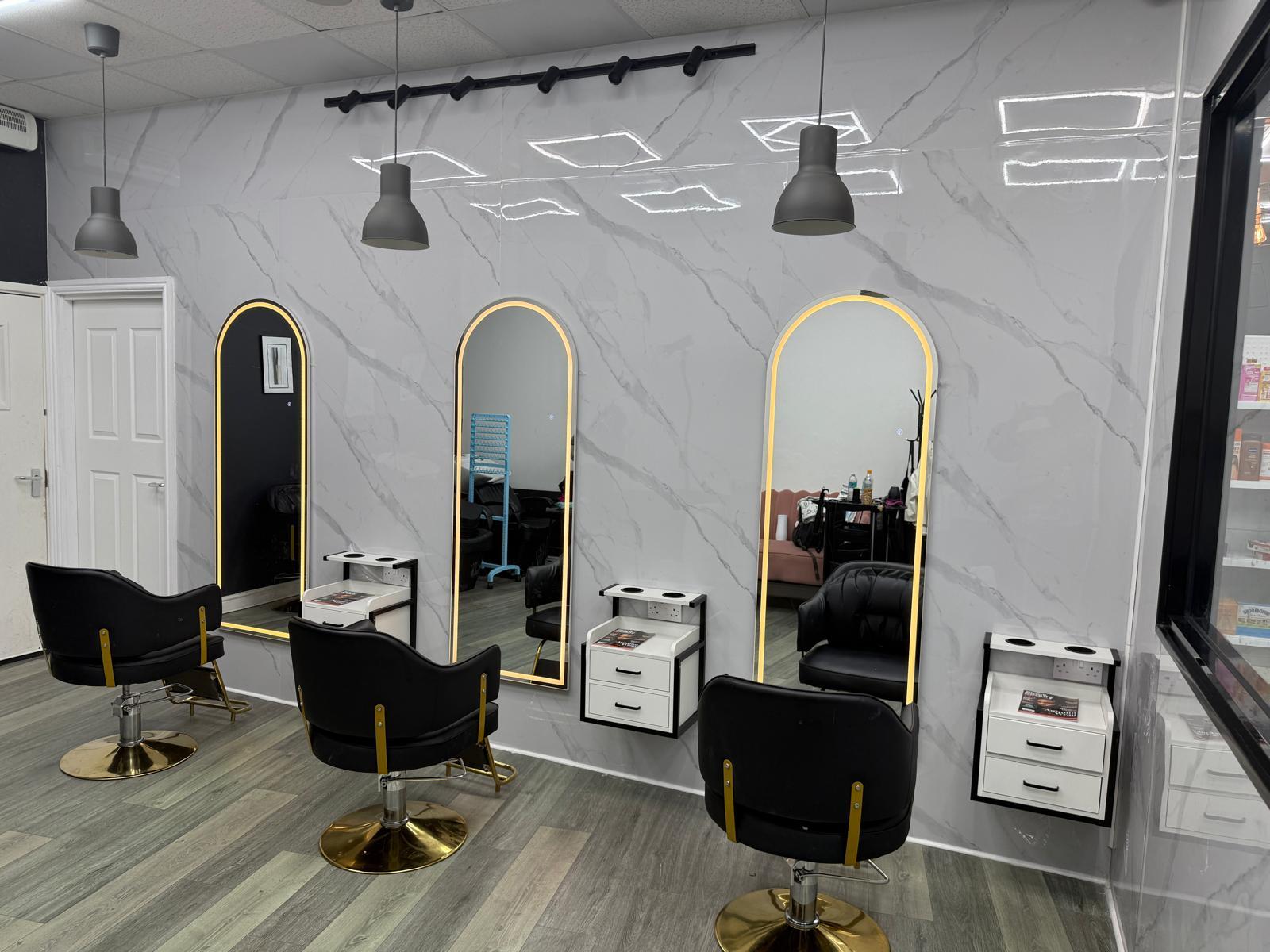 Shampoo basins and black chairs in the BIM-GOLD salon